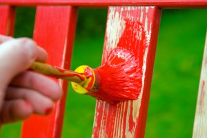 Stuhl wird in Rot gestrichen
